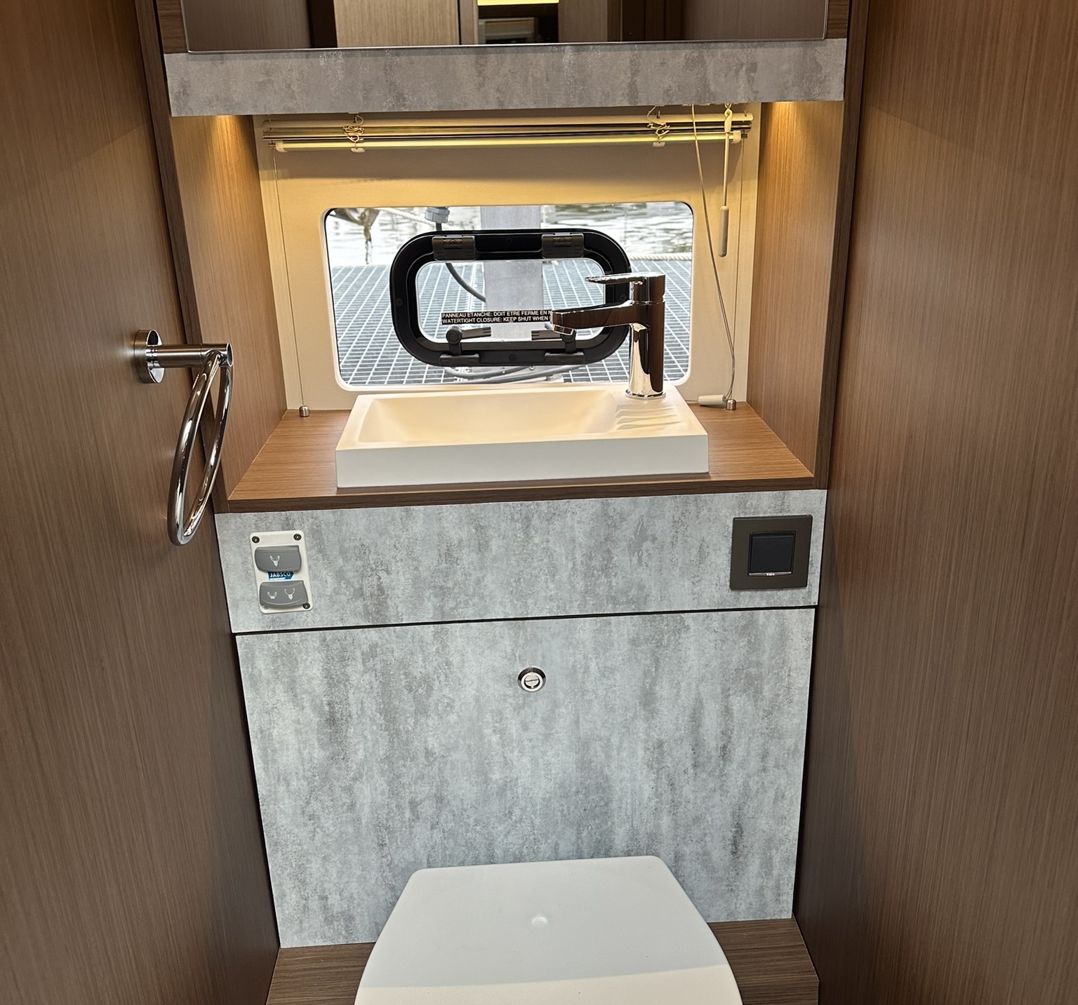 Yacht interior bathroom afterwards - modern stone look with gray concrete foil and wood accents